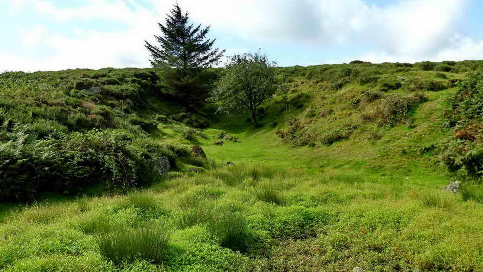 To the south of the building is a disused quarry, labelled as Old Sand Pit on some maps and dated to early 20th, so it came after the rifle range