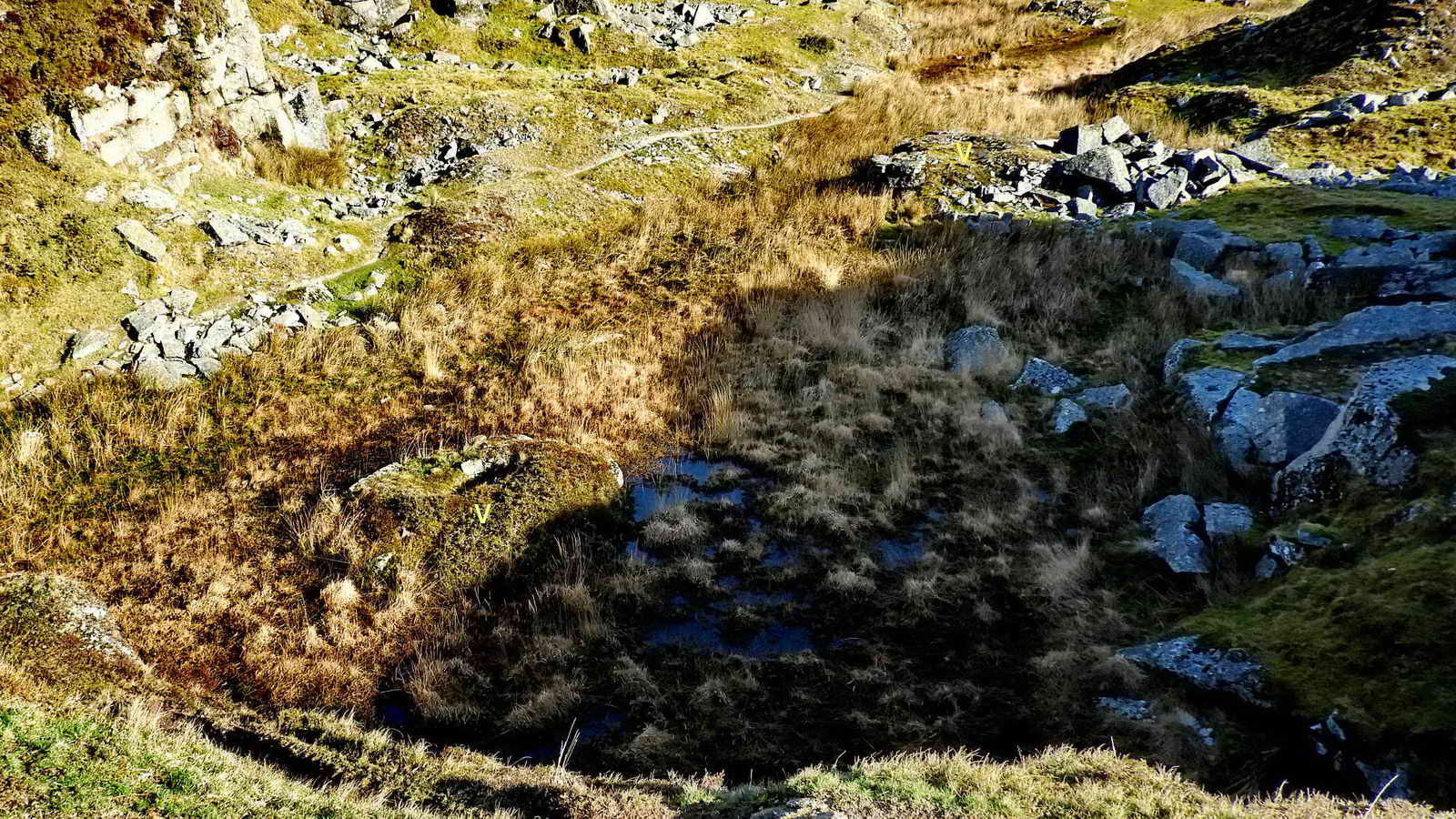  Looking down into the quarry from a quite high vantage point - at two crane bases (with yellow “v” labels)