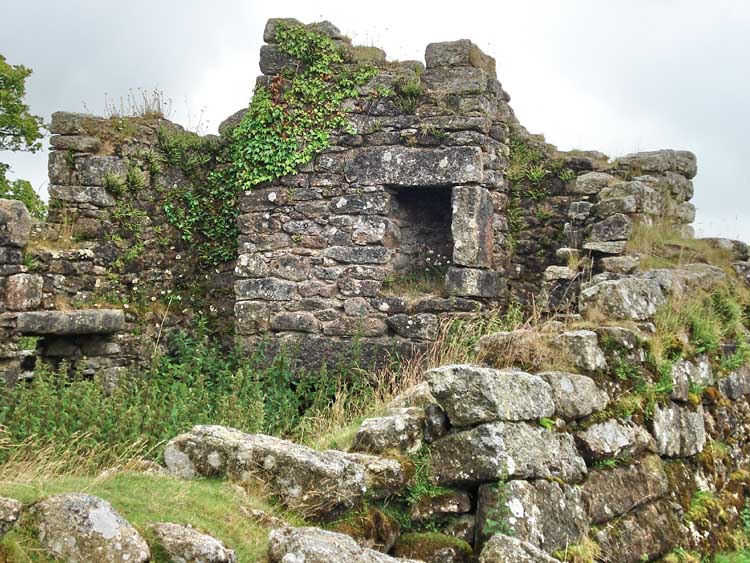 A view around the side of the house, showing the lintel of the upstairs fireplace