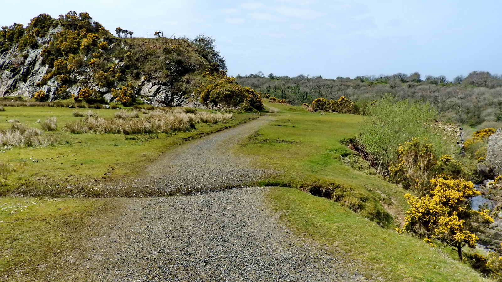 The track towards Meldon Dam with the Southern aplite quarry on the left, and the ruined pier of a bridge to the right