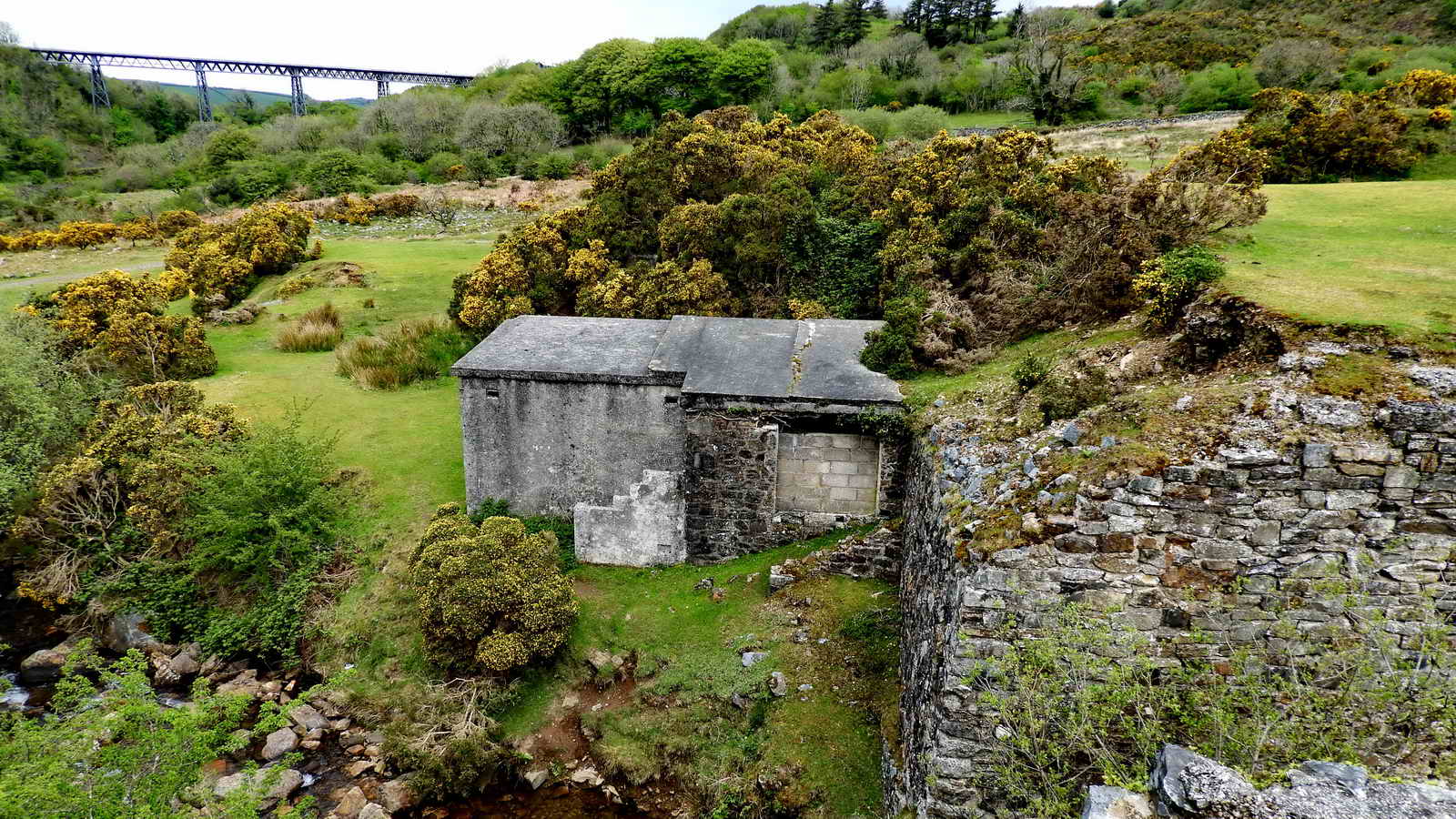 Just below the bridge abutments there is a small building