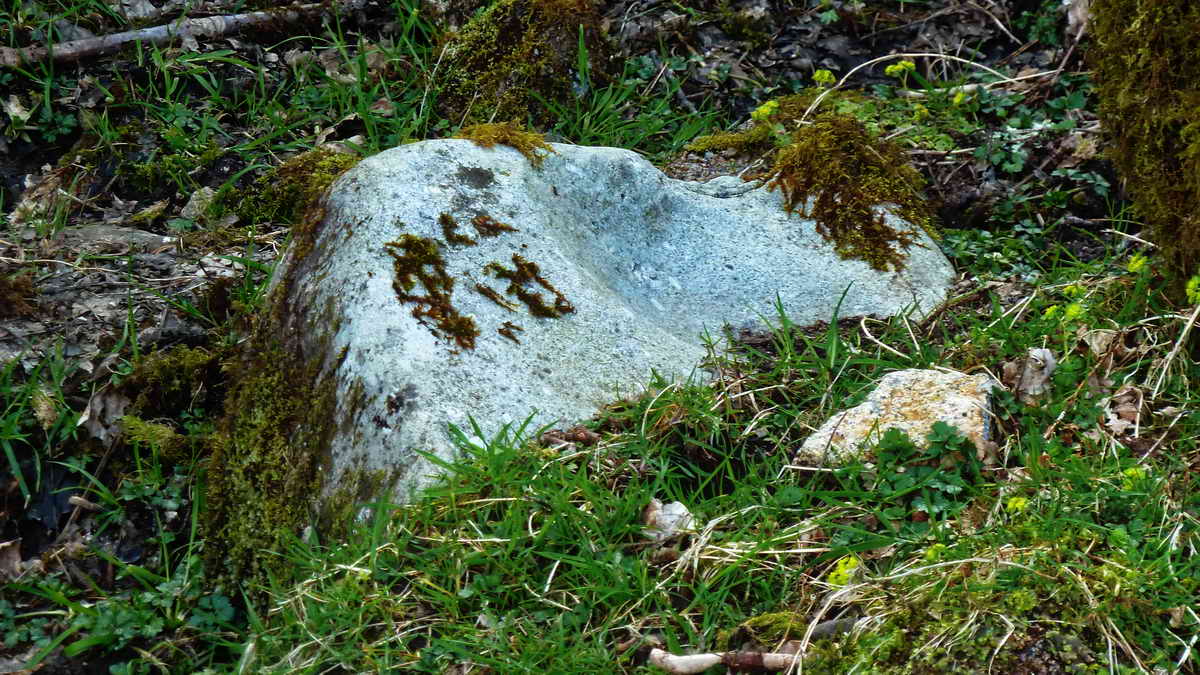 Close view of a broken mortar stone in the “blowing house”