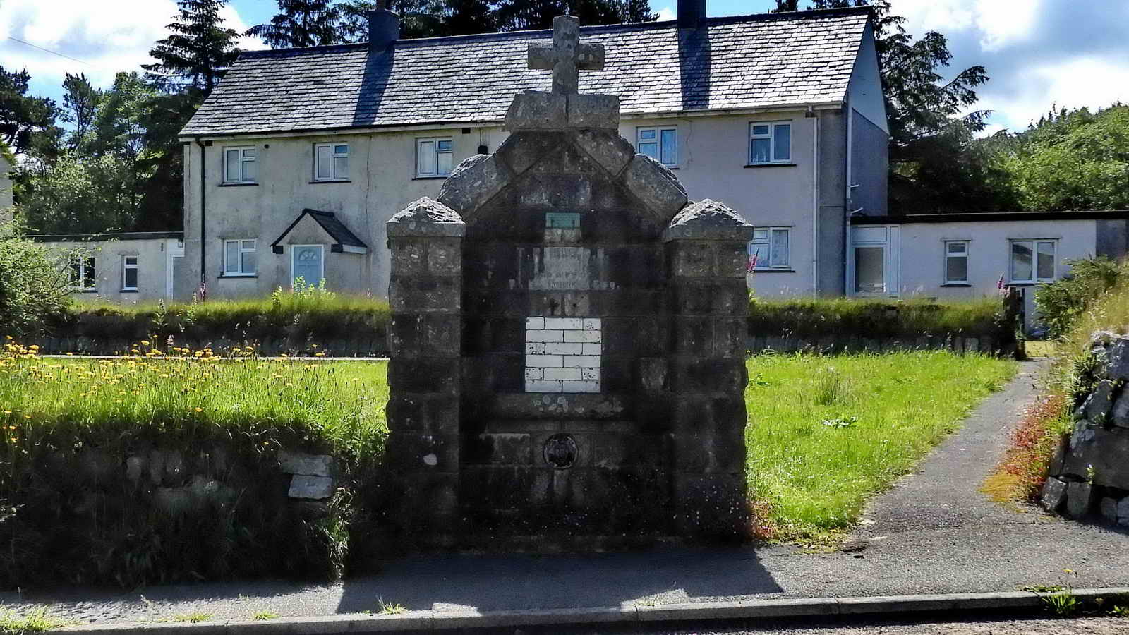 One of two 1908 now-defunct drinking fountains. This one is beside Two Bridges Road in front of Oakery Crescent and  the other is beside the Prince of Wales public house on the road to the prison