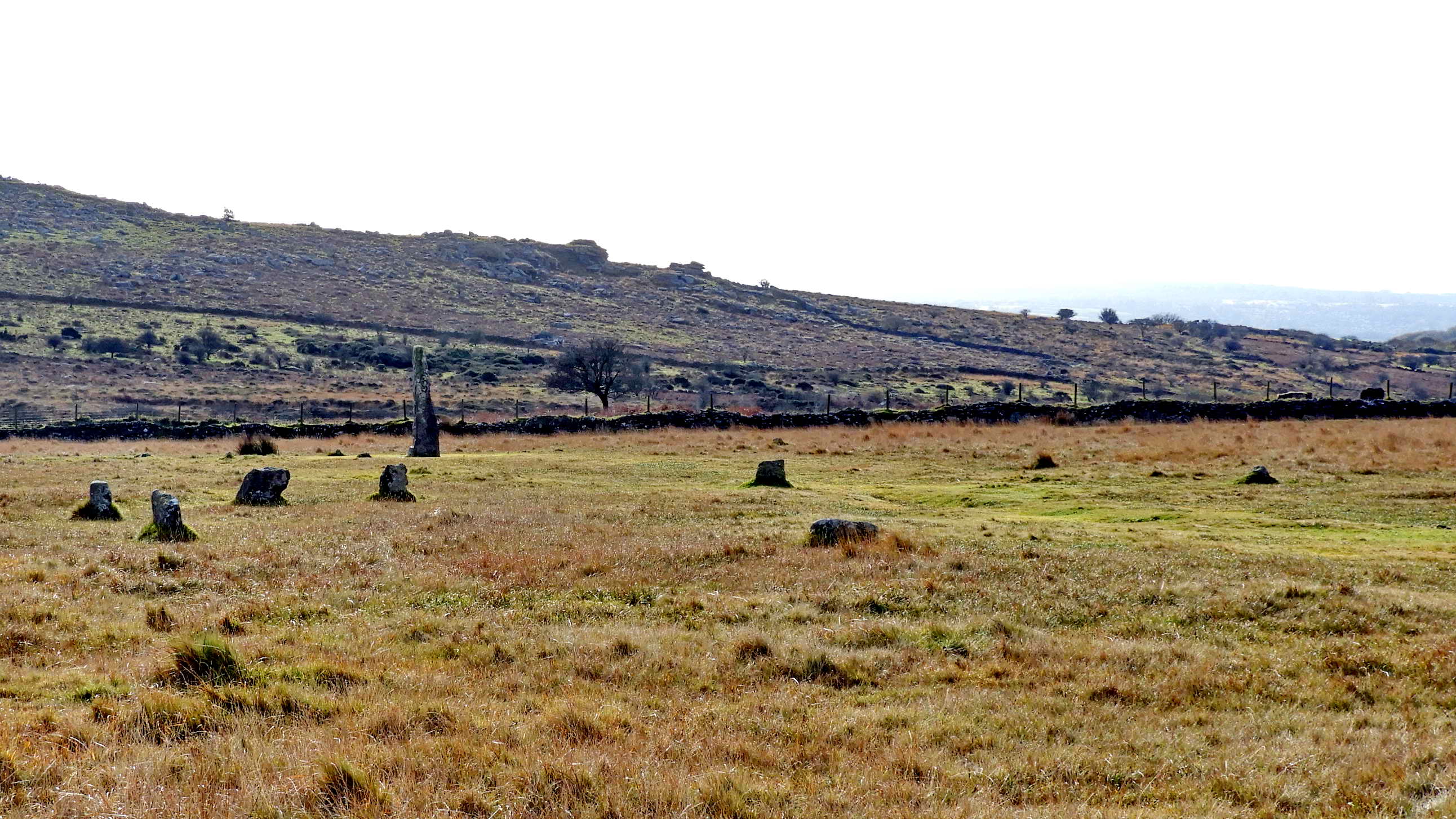 A view of the Merrivale stone circle and menhir. Midsummer sunset can be seen from the circle as the sun goes down in the notch of Middle Staple Tor