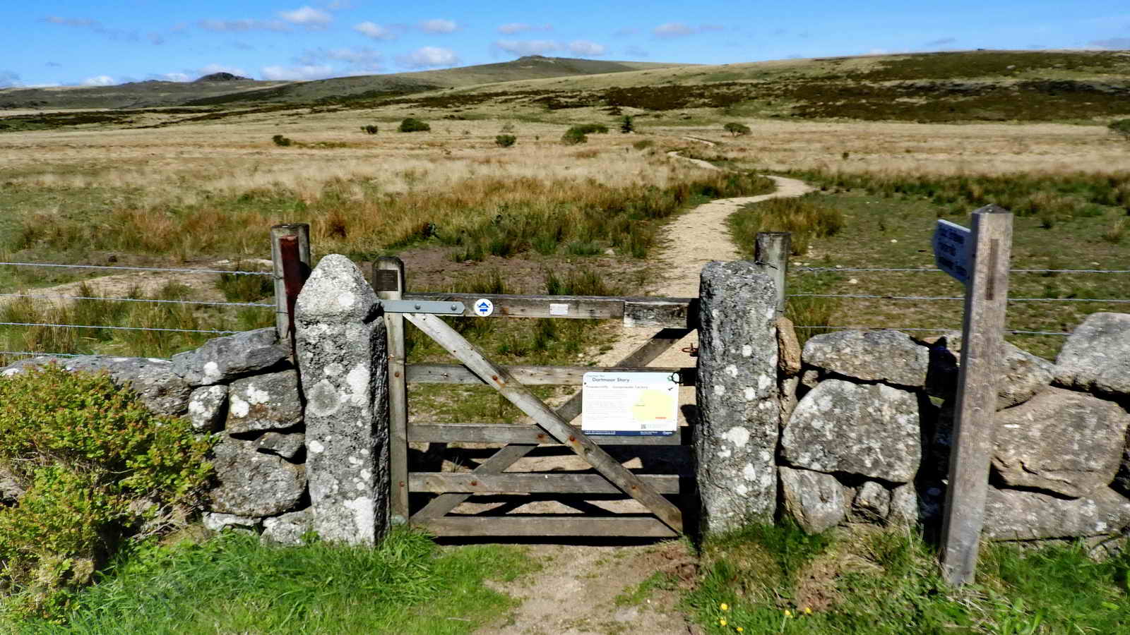 Across the road, the new path that was made in 1999. The old path was down the road to the left at Cherry Brook Bridge - a path that had become very boggy. In the distance is Longaford Tor (left), Higher White Tor (centre) and Arch Tor (right). The diversion of the path can be seen as a kink on modern walking route maps