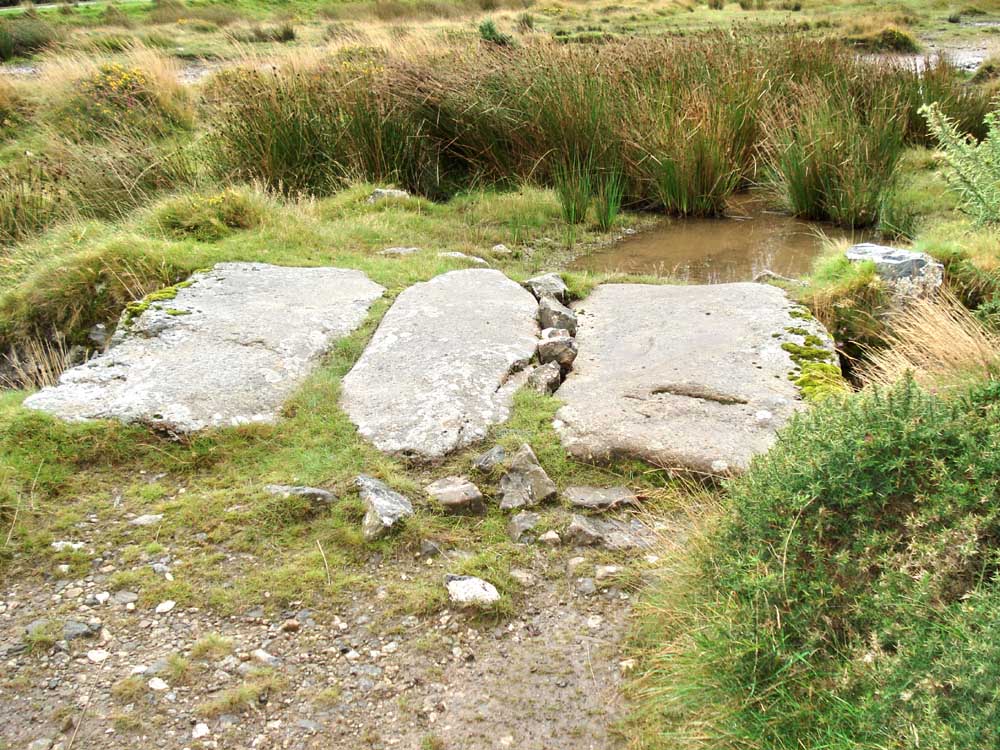 Walking westwards, a clapper bridge over the old leat
