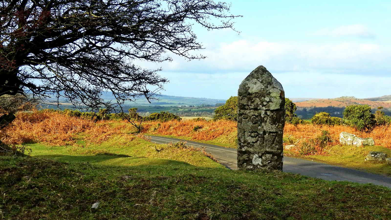 There is a PCWW 1917 (Plymouth Corporation Water Works) catchment boundary pillar built into the wall between the two car park entrances at Lowery Cross, at SX 54773 69243. Pew Tor can be seen towards the right edge